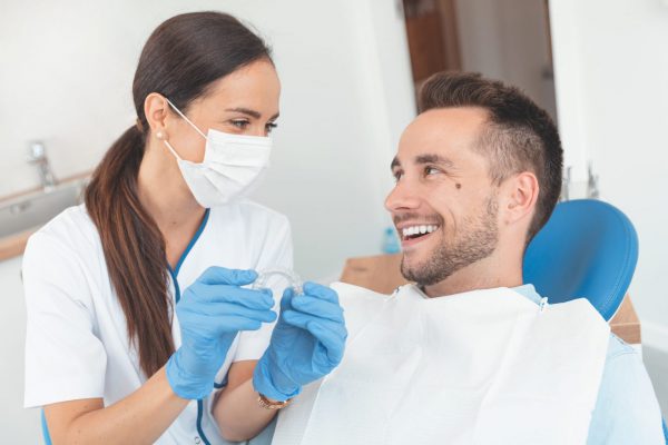 cambridge dentist holding a invisalign clear aligner