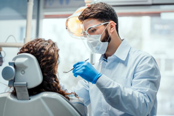 general dentist at cambridge clinic performing dental treatment