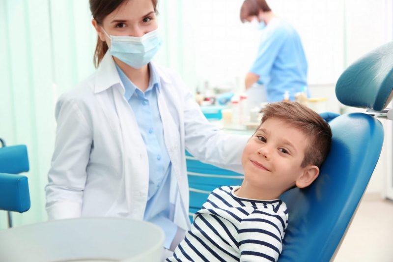 smiling boy at dentist chair in cambridge